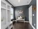 Stylish entryway with dark gray walls, white trim, wood floors, and a built-in storage bench at 6840 Canyon Creek Way, Cumming, GA 30028