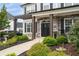 Inviting front entrance with pergola, stone accents, and lush landscaping at 6840 Canyon Creek Way, Cumming, GA 30028