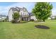 Well-maintained lawn and landscaping enhance this home's curb appeal at 6840 Canyon Creek Way, Cumming, GA 30028