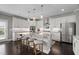 Modern kitchen featuring white cabinetry, stainless steel appliances, and a large island at 6840 Canyon Creek Way, Cumming, GA 30028