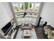 Lofted view of the spacious living room featuring tall windows, a fireplace, and an open layout to the dining area at 6840 Canyon Creek Way, Cumming, GA 30028