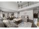 Open concept living room with view of the kitchen, and a large sofa set at 6840 Canyon Creek Way, Cumming, GA 30028