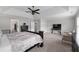 Spacious main bedroom featuring tray ceilings, a ceiling fan and neutral decor at 6840 Canyon Creek Way, Cumming, GA 30028
