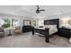 Elegant main bedroom with a tray ceiling, carpet flooring, and large windows with a view of the backyard at 6840 Canyon Creek Way, Cumming, GA 30028