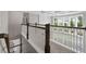 Upstairs hallway with wood and white railing overlooking living room at 6840 Canyon Creek Way, Cumming, GA 30028