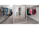 Large walk-in closet with ample shelving, storage, and a mirror for dressing area at 6840 Canyon Creek Way, Cumming, GA 30028