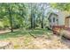 View of the spacious backyard surrounded by mature trees, plus wooden deck at 3120 Westwood Dr, Acworth, GA 30102