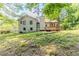 Spacious backyard with mature trees surrounding the property plus wooden deck at 3120 Westwood Dr, Acworth, GA 30102
