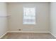 Cozy bedroom with neutral carpet, white walls, and a bright window at 3120 Westwood Dr, Acworth, GA 30102