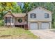Charming two-story home with a bay window, a two-car garage, and a partially wooded lot at 3120 Westwood Dr, Acworth, GA 30102