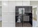 Modern black refrigerator surrounded by white cabinets and wood-look flooring at 3120 Westwood Dr, Acworth, GA 30102