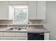 Stainless steel double sinks and black dishwasher below window in kitchen at 3120 Westwood Dr, Acworth, GA 30102
