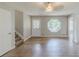 Open-concept living room with hardwood floors, a unique window, and neutral paint at 3120 Westwood Dr, Acworth, GA 30102