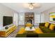 Bright living room featuring a stone fireplace, hardwood floors, and modern furnishings at 3120 Westwood Dr, Acworth, GA 30102