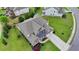 Aerial view of a landscaped home with a long driveway and well-manicured lawn at 7470 Oldbury Pl, Cumming, GA 30040