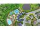 Aerial view of community amenities including a pool, tennis courts, parking, playground and a pond surrounded by trees at 7470 Oldbury Pl, Cumming, GA 30040