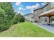 Expansive backyard with lush green grass, a grilling area, and a gazebo-covered patio at 7470 Oldbury Pl, Cumming, GA 30040