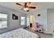 Light blue bedroom with a ceiling fan and two windows, and lots of toys at 7470 Oldbury Pl, Cumming, GA 30040