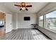 Bright bonus room with wood-look flooring, ceiling fan, and multiple windows, offering a flexible and inviting space at 7470 Oldbury Pl, Cumming, GA 30040