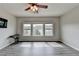 Spacious bonus room with lots of natural light and wood-look floors and ceiling fan at 7470 Oldbury Pl, Cumming, GA 30040