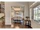 Formal dining room entrance featuring a coffered ceiling, chandelier, and hardwood floors at 7470 Oldbury Pl, Cumming, GA 30040