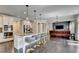 Spacious kitchen with island seating, stainless steel appliances, and open view to a living area at 7470 Oldbury Pl, Cumming, GA 30040