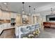 Open kitchen boasts granite counters, an island with seating and stainless steel appliances at 7470 Oldbury Pl, Cumming, GA 30040