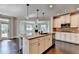 Kitchen with stainless steel appliances, white cabinetry, granite countertops, and hardwood floors at 7470 Oldbury Pl, Cumming, GA 30040