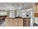 Kitchen island with granite countertops, stainless steel appliances and view of the adjoining living room at 7470 Oldbury Pl, Cumming, GA 30040