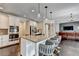 Open kitchen with large island, seating, granite countertops, stainless appliances, & hardwood floors throughout the home at 7470 Oldbury Pl, Cumming, GA 30040