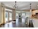 Open concept kitchen and living room with an stone fireplace and hardwood floors at 7470 Oldbury Pl, Cumming, GA 30040