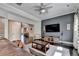 Inviting living room showcasing hardwood floors, a large TV, and comfortable seating arrangements at 7470 Oldbury Pl, Cumming, GA 30040