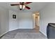 Cozy living room featuring wood-look floors, ceiling fan, and neutral paint at 7470 Oldbury Pl, Cumming, GA 30040