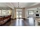 Open concept living area with an stone fireplace, hardwood floors, and natural light at 7470 Oldbury Pl, Cumming, GA 30040