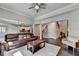 Open-concept living room with hardwood floors, a comfortable couch, and a view of the kitchen at 7470 Oldbury Pl, Cumming, GA 30040