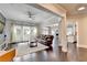 Spacious living room with dark hardwood floors, natural light, and open-concept design leading to the kitchen at 7470 Oldbury Pl, Cumming, GA 30040