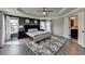Spacious main bedroom with tray ceiling, hardwood floors, and ensuite bathroom access, providing comfort and convenience at 7470 Oldbury Pl, Cumming, GA 30040