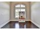 Neutral room with hardwood floors, white trim, and a display cabinet under a large arched window at 7470 Oldbury Pl, Cumming, GA 30040
