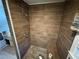 Tiled shower with built-in bench. Includes a separate sink and cabinet outside the shower at 1856 Butler Bridge Rd, Covington, GA 30016