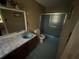 This bathroom features a toilet, a sink, a vanity, and a shower with sliding doors at 1856 Butler Bridge Rd, Covington, GA 30016