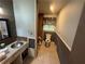 View of bathroom with tile floors, toilet, and wood paneling at 1856 Butler Bridge Rd, Covington, GA 30016