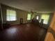 Large bedroom with hardwood floors, a ceiling fan, and multiple windows at 1856 Butler Bridge Rd, Covington, GA 30016