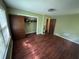 This bedroom features wood floors, a closet, and natural light from the window at 1856 Butler Bridge Rd, Covington, GA 30016
