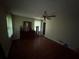Hardwood floors and a ceiling fan highlight this spacious bedroom with natural light at 1856 Butler Bridge Rd, Covington, GA 30016