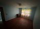 This bedroom features blue walls, a curtained window, and wood floors at 1856 Butler Bridge Rd, Covington, GA 30016