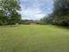 Expansive front yard of a single-story brick home surrounded by mature trees at 1856 Butler Bridge Rd, Covington, GA 30016