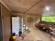 Enclosed garage with lawn mower, tools, refrigerator, storage, and view of the yard through a window at 1856 Butler Bridge Rd, Covington, GA 30016