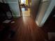 Hallway with dark wood floors leading to an open doorway into the kitchen area at 1856 Butler Bridge Rd, Covington, GA 30016