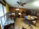 Spacious eat-in kitchen featuring classic wood cabinets, laminate floors, and an overhead fan at 1856 Butler Bridge Rd, Covington, GA 30016