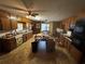 This spacious eat-in kitchen features wood cabinets, laminate floors, and ample countertop space at 1856 Butler Bridge Rd, Covington, GA 30016